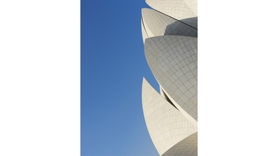 The Lotus Temple viewed from the leisurely horizontal comforts of the nearly infinite and immaculate green lawns surrounding the temple and its many water gardens, providing an architectural match to the sprawling flora and fauna with its own concrete flower petals as its crown. (Nikola Olić ) The Lotus Temple viewed from the leisurely horizontal comforts of the nearly infinite and immaculate green lawns surrounding the temple and its many water gardens, providing an architectural match to the sprawling flora and fauna with its own concrete flower petals as its crown. (Nikola Olić )