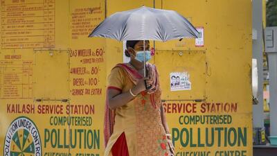 For Representation only: A woman walks under an umbrella to protect herself from the scorching heat (PTI File) For Representation only: A woman walks under an umbrella to protect herself from the scorching heat (PTI File)