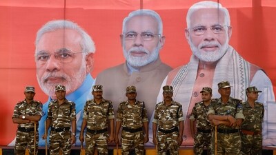 Military personnel stand watch as people wait for India's Prime Minister Narendra Modi's arrival for a roadshow, ahead of the general elections, in Ghaziabad, India, April 6, 2024. (REUTERS)