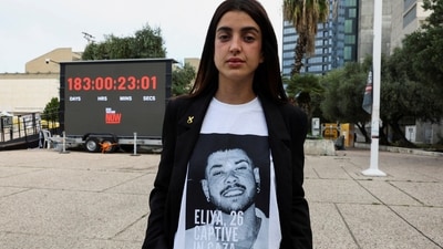 Ziv Abud, the girlfriend of hostage Eliya Cohen, who was kidnapped during the October 7 attack on Israel by Palestinian Islamist group Hamas from Gaza, shows her t-shirt with a picture of Eliya during an interview with Reuters, in Tel Aviv, Israel (REUTERS)