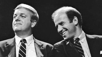 FILE - Maine Gov. Joseph Brennan, left, enjoys a laugh with U.S. Sen. Joseph Biden of Delaware during the opening ceremonies at Maine's Democratic presidential straw poll in Augusta, Maine, Friday, Sept. 30, 1983. Brennan, whose hardscrabble childhood shaped his working class views in a political career that included two terms as governor and two terms in the US. House, died Friday evening, April 5, 2024, at his home in Portland, Maine. He was 89. (AP Photo/Pat Wellenbach, File) (AP) FILE - Maine Gov. Joseph Brennan, left, enjoys a laugh with U.S. Sen. Joseph Biden of Delaware during the opening ceremonies at Maine's Democratic presidential straw poll in Augusta, Maine, Friday, Sept. 30, 1983. Brennan, whose hardscrabble childhood shaped his working class views in a political career that included two terms as governor and two terms in the US. House, died Friday evening, April 5, 2024, at his home in Portland, Maine. He was 89. (AP Photo/Pat Wellenbach, File) (AP)