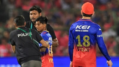 A fan of Virat Kohli being taken out of the field by ground staff. (PTI) A fan of Virat Kohli being taken out of the field by ground staff. (PTI)