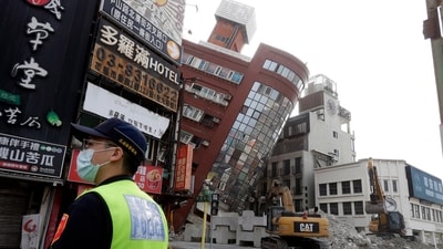 A police officer stands guard near a partially collapsed building after a powerful earthquake struck eastern Taiwan on April 3. (AP Photo/Chiang Ying-ying) A police officer stands guard near a partially collapsed building after a powerful earthquake struck eastern Taiwan on April 3. (AP Photo/Chiang Ying-ying)