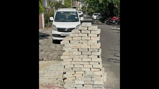 Interlocking tiles stacked up on the roadside in Sarabha Nagar area in Ludhiana on Sunday. (Gurpreet Singh/HT)