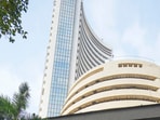 Mumbai: People move past a digital screen at the facade of the BSE during the presentation of the Interim Budget 2024 in Parliament by Union Finance Minister Nirmala Sitharaman, in Mumbai, Thursday, Feb. 1, 2024.  (PTI Photo/Shashank Parade) (PTI02_01_2024_000217A)