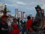 People gather two days ahead of a total solar eclipse at the Malecon in Mazatlan, Mexico April 6, 2024. REUTERS/Henry Romero