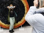 A visitor poses for a photograph in front of a solar eclipse themed display in Niagara Falls, Ontario, Canada. A total solar eclipse will occur across North America on Monday.(Bloomberg)