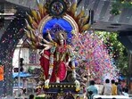 Chaitra Navratri 2024: Devotees transport an idol of Goddess Durga to a community pandal at Lalbaug in Mumbai.(PTI)