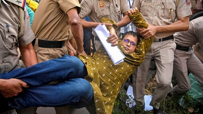 Delhi Police personnel detain TMC leader Saket Gokhale during a dharna of a TMC delegation after a meeting with Election Commission of India (ECI), outside ECI's office. (PTI) Delhi Police personnel detain TMC leader Saket Gokhale during a dharna of a TMC delegation after a meeting with Election Commission of India (ECI), outside ECI's office. (PTI)