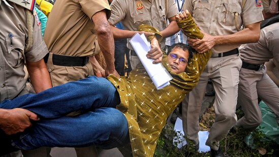 Delhi Police personnel detain TMC leader Saket Gokhale during a dharna of a TMC delegation after a meeting with Election Commission of India (ECI), outside ECI's office. (PTI)