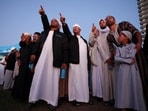 Muslims gesture as they await the sighting of the crescent moon that marks the end of the holy month of Ramadan.
