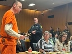 Defendant James Crumbley speaks before his sentencing for involuntary manslaughter in a school shooting committed by his son, Tuesday, April 9, 2024, in Pontiac, Mich. His wife, Jennifer Crumbley, center, listens. The Crumbleys were each sentenced to at least 10 years in prison Tuesday for failing to take steps that could have prevented the killing of four students in 2021. (AP Photo/Ed White)