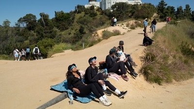 Spectators use special glasses to watch a solar eclipse near Griffith Observatory in Los Angeles. (AP) Spectators use special glasses to watch a solar eclipse near Griffith Observatory in Los Angeles. (AP)