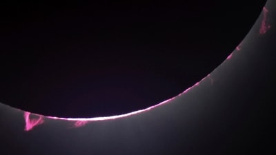 Solar flares and a solar prominence are seen as the moon covers the sun during a total solar eclipse seen from Progressive Field in Cleveland on Monday, April 8, 2024, before the Cleveland Guardians home opener baseball game against the Chicago White Sox. AP/PTI(AP04_09_2024_000010A) (AP) Solar flares and a solar prominence are seen as the moon covers the sun during a total solar eclipse seen from Progressive Field in Cleveland on Monday, April 8, 2024, before the Cleveland Guardians home opener baseball game against the Chicago White Sox. AP/PTI(AP04_09_2024_000010A) (AP)
