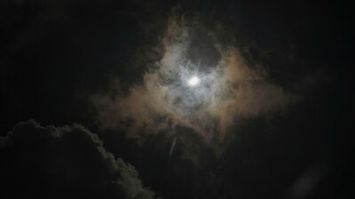 The moon partially covers the sun during a total solar eclipse, as seen through clouds from the air in a Cessna 172 aircraft, at about 5,000 ft., over in Arkadelphia, Ark., within the path of totality. (AP) The moon partially covers the sun during a total solar eclipse, as seen through clouds from the air in a Cessna 172 aircraft, at about 5,000 ft., over in Arkadelphia, Ark., within the path of totality. (AP)
