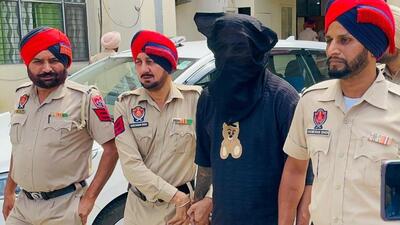 Nature Heights Infra Ltd scam main accused Neeraj Thatai (face covered) in Punjab Police custody on Tuesday after he was arrested from Pauri district of Uttarakhand. (HT Photo) Nature Heights Infra Ltd scam main accused Neeraj Thatai (face covered) in Punjab Police custody on Tuesday after he was arrested from Pauri district of Uttarakhand. (HT Photo)