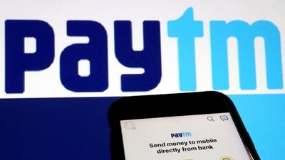 The interface of Indian payments app Paytm is seen in front of its logo. Paytm has seen its transaction value market share drop to 6.7%. (Reuters)