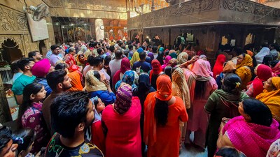 Devotees stood in long queues waiting to offer 'Pooja' and 'Prasad' to Hindu goddess Durga. (PTI) Devotees stood in long queues waiting to offer 'Pooja' and 'Prasad' to Hindu goddess Durga. (PTI)