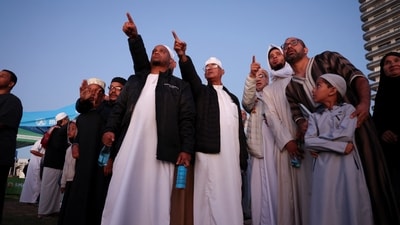 Muslims gesture as they await the sighting of the crescent moon that marks the end of the holy month of Ramadan. (Representative Image/REUTERS)