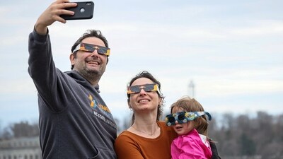 A family poses for a selfie during a total solar eclipse at Niagara Falls, New York, U.S. (REUTERS)