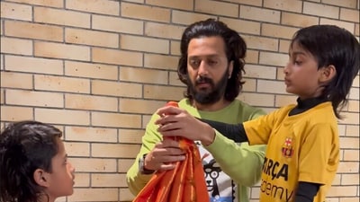 Riteish Deshmukh prepares the gudi for the festival with his sons while wife Genelia Deshmukh films them. Riteish Deshmukh prepares the gudi for the festival with his sons while wife Genelia Deshmukh films them.