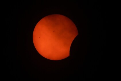 Clouds roll by as the beginning phase of a total solar eclipse is visible from Arlington, Texas, Monday, April 8, 2024.AP/PTI(AP04_08_2024_000288A) (AP) Clouds roll by as the beginning phase of a total solar eclipse is visible from Arlington, Texas, Monday, April 8, 2024.AP/PTI(AP04_08_2024_000288A) (AP)