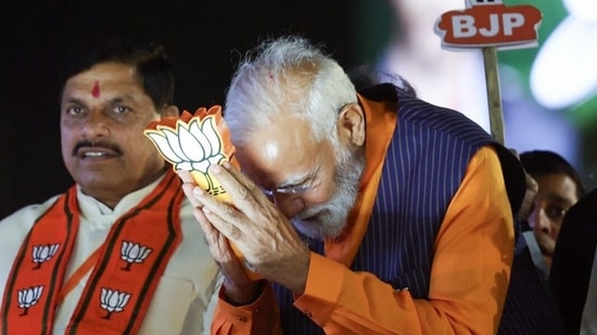 Prime Minister Narendra Modi greets the gathering as he holds a roadshow with Madhya Pradesh chief minister Mohan Yadav in support of BJP ahead of Lok Sabha polls in Jabalpur on Sunday. (Narendra Modi-X)