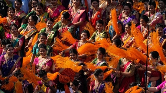 Women dressed in traditional attire dance during a procession to mark Gudi Padwa or the Marathi New Year in Mumbai.(AP)