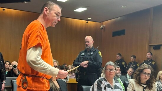 Defendant James Crumbley speaks before his sentencing for involuntary manslaughter in a school shooting committed by his son, Tuesday, April 9, 2024, in Pontiac, Mich. His wife, Jennifer Crumbley, center, listens. The Crumbleys were each sentenced to at least 10 years in prison Tuesday for failing to take steps that could have prevented the killing of four students in 2021. (AP Photo/Ed White) (AP)