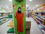 A hoarding with an image of Baba Ramdev is seen inside a Patanjali store. 