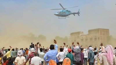 Rashtriya Janta Dal (RJD) supporters wave at party leader Tejashwi Yadav's helicopter as he leaves after addressing a public meeting at Rafiganj in Aurangabad district, Bihar. (PTI) Rashtriya Janta Dal (RJD) supporters wave at party leader Tejashwi Yadav's helicopter as he leaves after addressing a public meeting at Rafiganj in Aurangabad district, Bihar. (PTI)