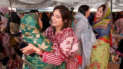 Muslim women share Eid greeting after performing an Eid-ul-Fitr prayer at historical Badshahi mosque in Lahore, Pakistan on Wednesday. (AP) Muslim women share Eid greeting after performing an Eid-ul-Fitr prayer at historical Badshahi mosque in Lahore, Pakistan on Wednesday. (AP)