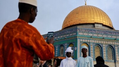 Muslims stand together to be photographed at Al-Aqsa compound, also known to Jews as Temple Mount, on Eid-ul-Fitr amid the ongoing conflict in Gaza between Israel and Palestinian Islamist group Hamas, in Jerusalem's Old City on Wednesday. (REUTERS)