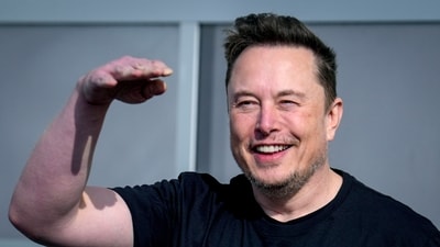 Tesla CEO Elon Musk waves as he leaves the Tesla Gigafactory for electric cars after a visit in Gruenheide near Berlin, Germany. (AP)