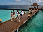 FILE- Foreign tourists arrive in a resort in the Kurumba island in Maldives, Feb. 12, 2012. Relationship between India and the Maldives is facing challenges after officials in the tiny island nation made derogatory remarks against Prime Minister Narendra Modi’s posts that promoted the pristine beaches of India’s Lakshadweep archipelago. (AP Photo/ Gemunu Amarasinghe, File)