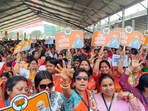 BJP supporters cheer during an election campaign rally addressed by PM Narendra Modi ahead of the upcoming Lok Sabha polls, in Cooch Behar district.
