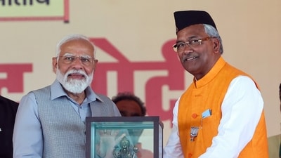 PM Narendra Modi was felicitated by Bharatiya Janata Party (BJP) candidate Trivendra Singh Rawat during the public meeting in Rishikesh. (BJP) PM Narendra Modi was felicitated by Bharatiya Janata Party (BJP) candidate Trivendra Singh Rawat during the public meeting in Rishikesh. (BJP)