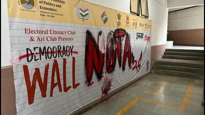 According to institute authorities, the miscreants defaced a poster using graffiti spray paint as they struck out the word ‘Democracy’ from the poster and wrote ‘NOTA 2024’ along with ‘Inquilab Zindabad’ (long live the revolution) on it. (HT PHOTO) According to institute authorities, the miscreants defaced a poster using graffiti spray paint as they struck out the word ‘Democracy’ from the poster and wrote ‘NOTA 2024’ along with ‘Inquilab Zindabad’ (long live the revolution) on it. (HT PHOTO)