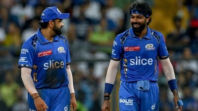 Mumbai Indians' captain Hardik Pandya and his teammate Rohit Sharma (L) talk during the IPL match against Royal Challengers Bengaluru (AFP) Mumbai Indians' captain Hardik Pandya and his teammate Rohit Sharma (L) talk during the IPL match against Royal Challengers Bengaluru (AFP)