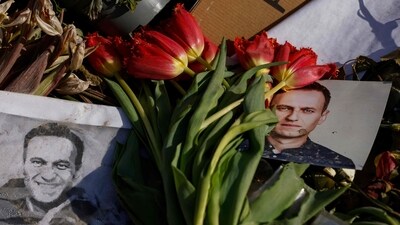 Flowers are left next to photos of the late Russian opposition leader Alexei Navalny. (AFP) Flowers are left next to photos of the late Russian opposition leader Alexei Navalny. (AFP)