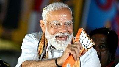 Prime Minister Narendra Modi holds the party symbol during a road show at an election campaign on April 9. (AFP) Prime Minister Narendra Modi holds the party symbol during a road show at an election campaign on April 9. (AFP)
