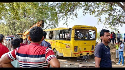 Locals near a damaged school bus after an accident near Mahendragarh in Narnaul district, Haryana on Thursday. (PTI)