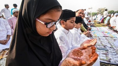Muslim children offer 'namaz' during Eid-ul-Fitr celebrations, at the historical Gandhi Maidan in Patna on Thursday. (PTI)