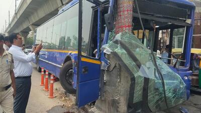 The bus rammed an advertising pole after going atop the divider. The bus rammed an advertising pole after going atop the divider.