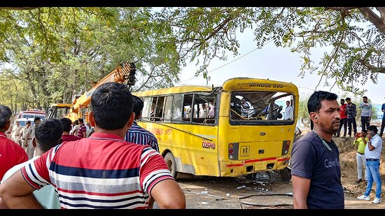 Locals near a damaged school bus after an accident near Mahendragarh in Narnaul district, Haryana on Thursday. (PTI)