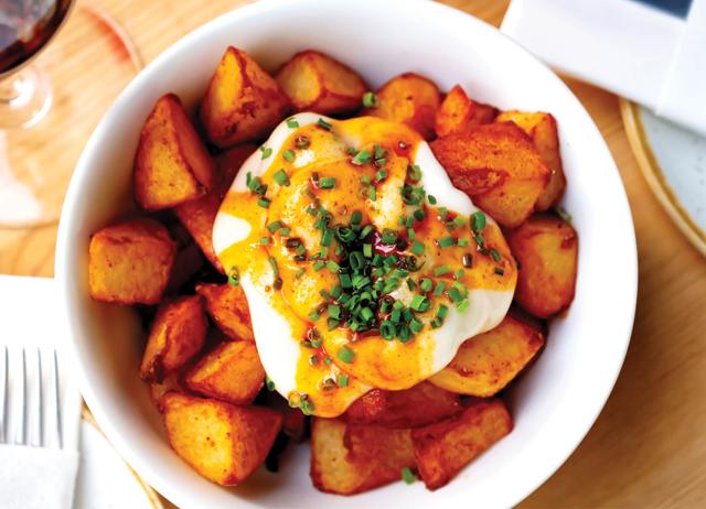 The food bazaar at Mercado Central, Barcelona, has patatas bravas: potatoes roasted on a tomato base. (Shutterstock) The food bazaar at Mercado Central, Barcelona, has patatas bravas: potatoes roasted on a tomato base. (Shutterstock)