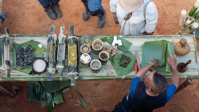 Dharmen Momin presenting a sumptuous Garo spread at Do-patchi Home stay in Sasagre village. The sakhan is on the banana leaf at extreme left. (Royal Enfield Social Mission) Dharmen Momin presenting a sumptuous Garo spread at Do-patchi Home stay in Sasagre village. The sakhan is on the banana leaf at extreme left. (Royal Enfield Social Mission)