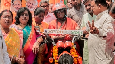 Bike rider Rajalaxmi Manda, also known as Bullet Rani, poses for photos with others during her bike tour election campaign in support of BJP and PM Narendra Modi in Kanpur, Uttar Pradesh. (PTI) Bike rider Rajalaxmi Manda, also known as Bullet Rani, poses for photos with others during her bike tour election campaign in support of BJP and PM Narendra Modi in Kanpur, Uttar Pradesh. (PTI)