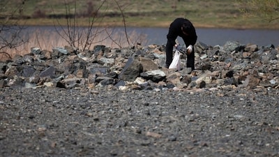 A woman searches for chrome from the scrap in Bulqiza, a city with one of the largest chromium reserves in Albania where a large amount of Hydrogen was recently discovered, in Bulqiza, Albania, March 31, 2024. REUTERS/Florion Goga (REUTERS)