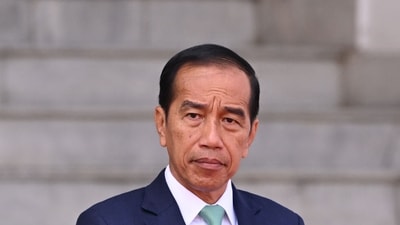 Indonesia's President Joko Widodo stands as he waits for Tanzania's President Samia Suluhu Hassan during a visit at the Bogor palace in Bogor, West Java on January 25, 2024. (Photo by Adek BERRY / AFP) (AFP)